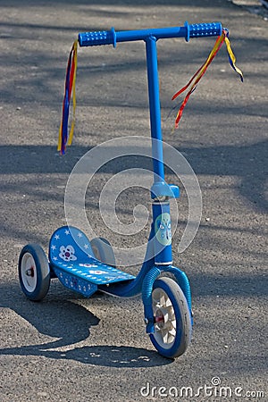 Small kids blue kick scooter Stock Photo