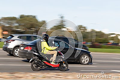 Scooters drive on the street in heavy traffic. Motion blur. Riga, Latvia - 09 Sep 2021 Editorial Stock Photo