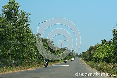 Scooters run on street in Quy Nhon, Vietnam Editorial Stock Photo