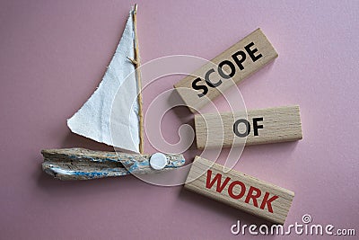 Scope of Work symbol. Concept words Scope of Work on wooden blocks. Beautiful pink background with boat. Business and Scope of Stock Photo