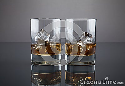 Scotch or bourbon filled glass tumblers Stock Photo
