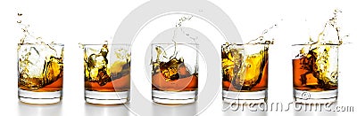 Scotch glasses with whiskey splashing from them Stock Photo