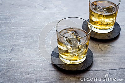 Scotch - two glasses with ice - on grey stone background copy space Stock Photo