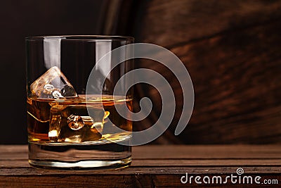 Scotch whiskey glass and old barrel Stock Photo