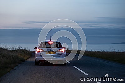 Opel Vauxhall Astra Combi Ecotec car on a Scottish roads at dusk with brake lights on and motion blur speed effect Editorial Stock Photo