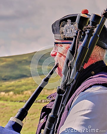 Scottish Bagpiper & Highlands - Close Up Editorial Stock Photo