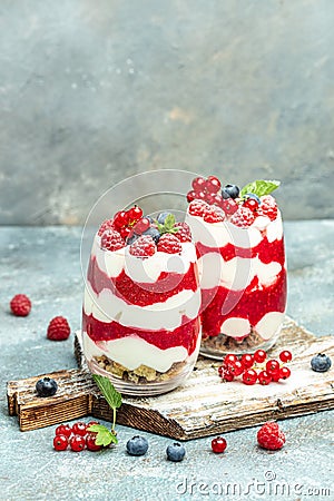 Scottish dessert whipped cream, roasted oatmeal and raspberries in jar. vertical image. top view. place for text Stock Photo