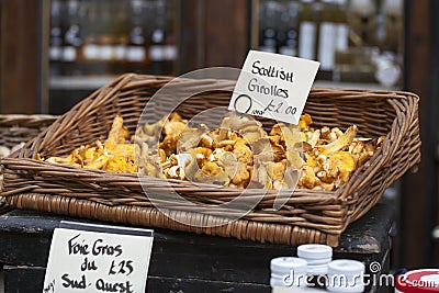 girolles in a wicker box that hangs on the wall, for sale on the market Stock Photo