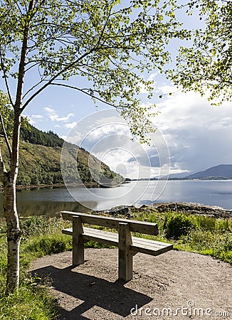 Scottish Loch with bench Stock Photo