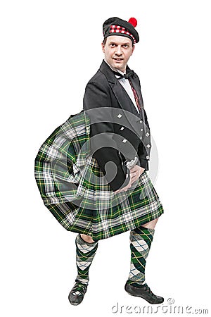 Scottish man in traditional national costume with blowing kilt Stock Photo