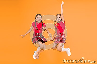 Scottish style. Cheerful friends schoolgirls jumping yellow background. Celebrate holiday. Scottish holiday. Join Stock Photo