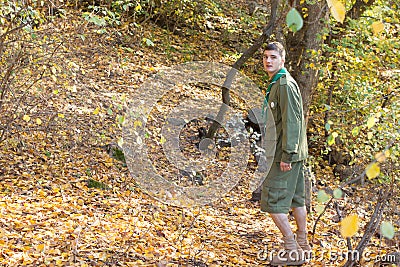 Scout or ranger walking through woodland Stock Photo