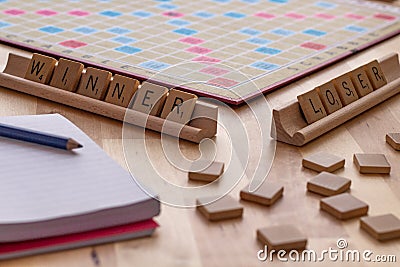 Scrabble board game with the scrabble tile spell `Winner Loser` Editorial Stock Photo