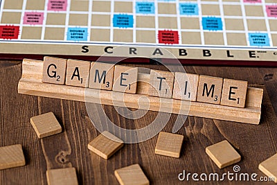 Scrabble board game with the scrabble tile spell `Game Time` Editorial Stock Photo