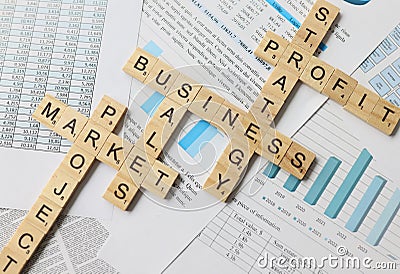 Scrabble, cubes with words on documents, close-up Stock Photo