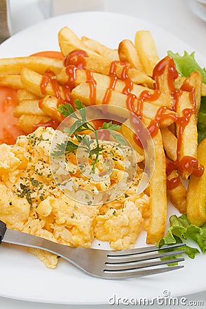 Scrambled egg with french fries Stock Photo