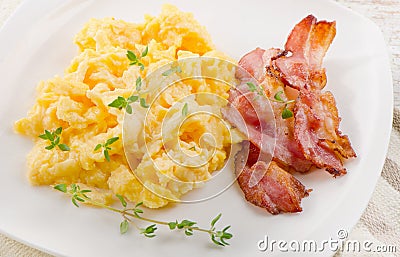 Scrambled eggs and bacon Stock Photo