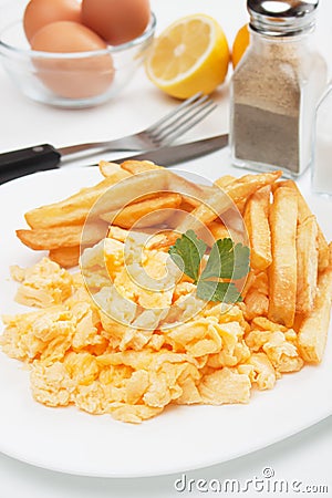 Scrambled eggs and french fries Stock Photo