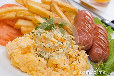 Scrambled eggs with french fries and sausage Stock Photo