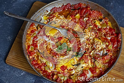 Scrambled eggs with tomatoes in the pan, shakshuka in the pan Stock Photo