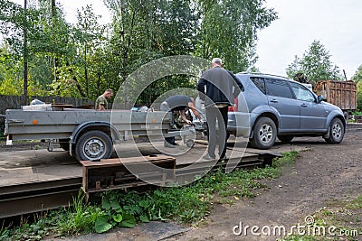 At the scrap metal collection point, a car trailer with metal stands on a scale. Editorial Stock Photo