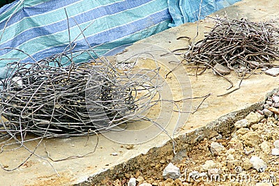 Scrap twisted steel iron metal rebars in construction site Stock Photo