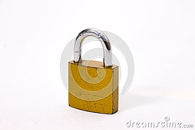 Scratched old yellow padlock closed Stock Photo