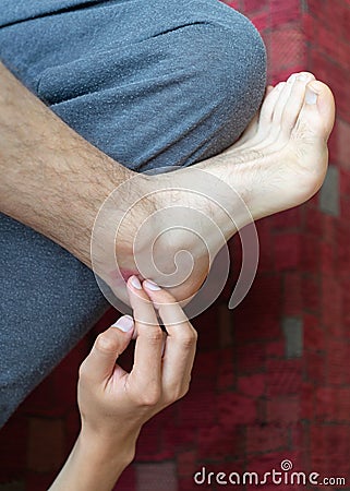 Scratching insect flea bite body chest foot by hand itch Stock Photo
