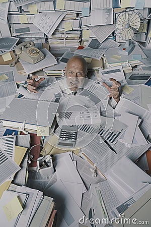 Screaming businessman drowning under a lot of paperwork Stock Photo