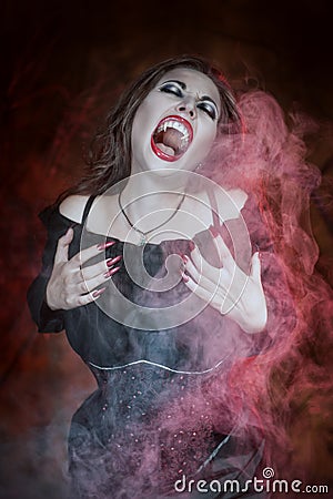 Screaming halloween beautiful vampire with long hair Stock Photo