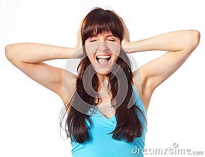 Screaming young woman holding head Stock Photo