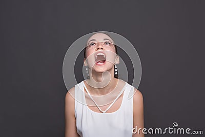 Screaming young woman looking up Stock Photo