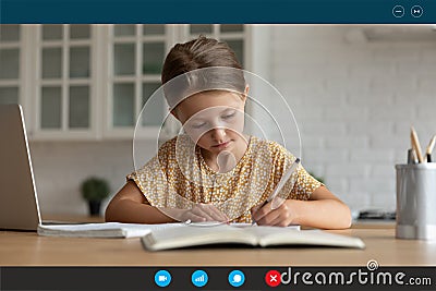 Screen view little girl studying online at home, writing notes Stock Photo