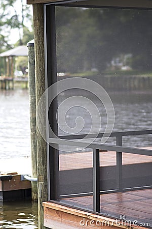 Screened enclosure on dock over water Stock Photo