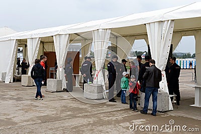 Screening of visitors at the International aviation and space salon MAKS-2013. The job of the police. Editorial Stock Photo