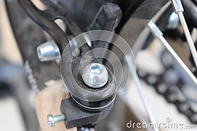 Screw on brakes of rear bicycle wheel Stock Photo