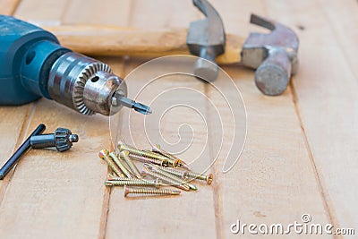 Screw,hammer and electric drill on wood Stock Photo