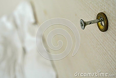 The screw sticks out in a piece of white wood. Stock Photo