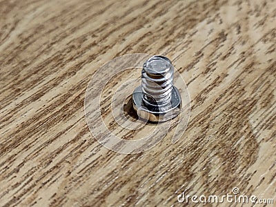 Screw on a wooden background Stock Photo