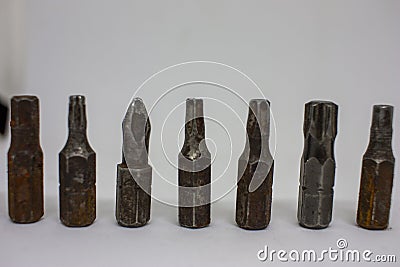 Old, rusty screwdriver bits on a white background. Close-up Stock Photo