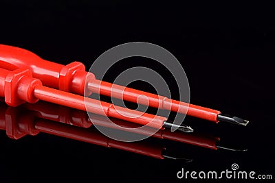 Screwdriver flat and screwdriver cross. Workshop tools. Reflection in black glass. Stock Photo