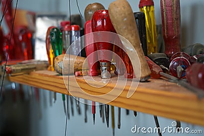 Various screwdrivers in a dusty wooden shelf in the workshop of a craftsman, selected focus Stock Photo