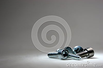 Screws on a grey background Stock Photo