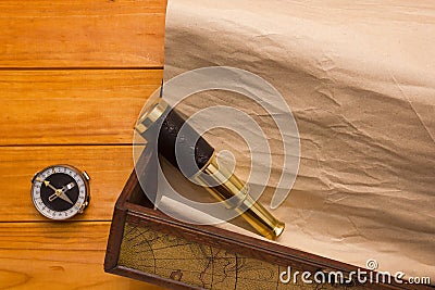 Scroll in the box, telescope and compass Stock Photo