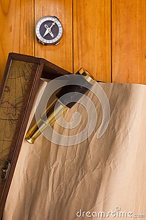 Scroll in the box, telescope and compass Stock Photo