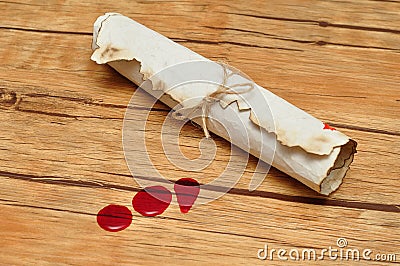 A scroll of paper tie up with rope and drops of blood Stock Photo