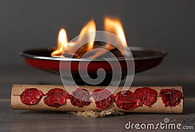 Scroll with seven seals in front of burning fire flames, Christian prophecy and revelation concept Stock Photo