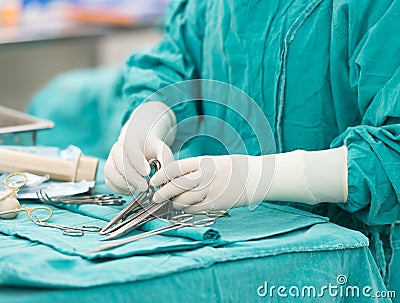 Scrub nurse preparing tools for operation Stock Photo