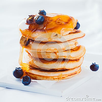 Scrumptious pancakes with honey and blueberries Stock Photo