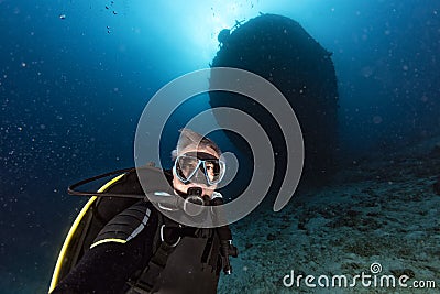 Scuba diver diving Ship Wreck in maldives indian ocean Stock Photo